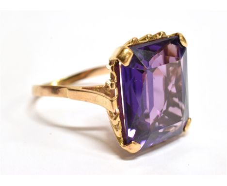 AN AMETHYST SINGLE STONE 9 CARAT GOLD DRESS RING  the rectangular mixed cut amethyst approx. 16mm x 13mm, four claw set to pl