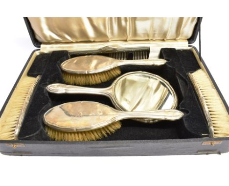 A SIX PIECE SILVER BACKED DRESSING TABLE BOXED SET  comprising hand mirror, two hairbrushes, two clothes brushes an comb, Che