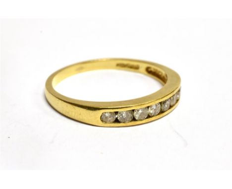 AN 18 CARAT GOLD HALF ETERNITY RING  the front channel set section comprising eight small round brilliant cut diamonds, total