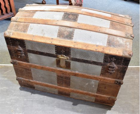 AN AMERICAN METAL BOUND DOME TOP TRAVELLING TRUNK  the fitted interior with lift-out compartments and trays, stencilled to ba