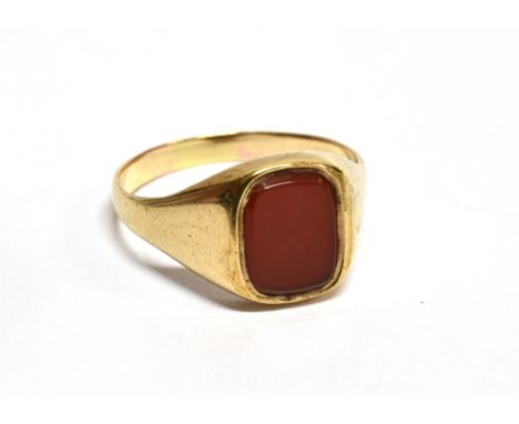 A CARNELIAN SET YELLOW GOLD SIGNET RING cushion shaped tablet of carnelian to a plain polished traditional form signet ring, 