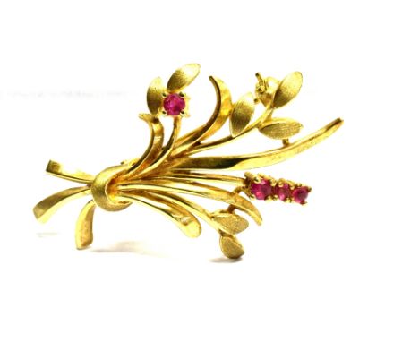 A 9 CARAT GOLD RUBY SET SPRAY BROOCH four small round cut rubies approx. 2mm diameter, roll over safety loop brooch fittings,