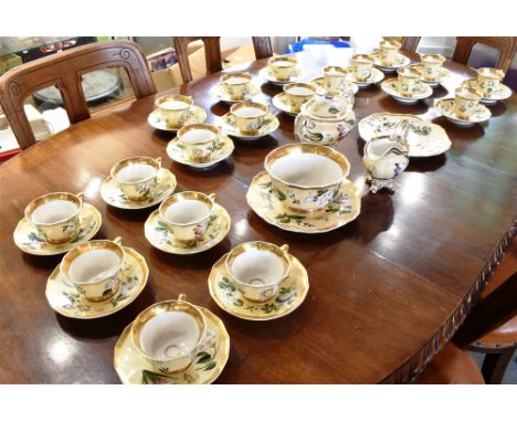 A LARGE COLLECTION OF COPELAND SPODE TEAWARES  with painted floral decoration on an ochre ground, within gilt borders