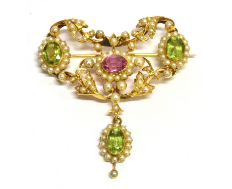 AN EDWARDIAN PINK TOURMALINE, PERIDOT AND SEED PEARL SET YELLOW GOLD DROP BROOCH the central oval mixed cut pink tourmaline a