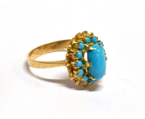 A TURQUOISE OVAL CLUSTER YELLOW GOLD RING the central oval cabochon cut turquoise approx. 10mm x 5mm, surround of small round