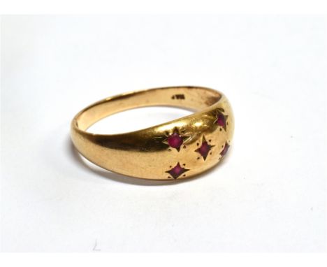 A 9 CARAT GOLD GRADUATING BAND RING gypsy set with five small rubies, ring size O, gross weight 2.0 grams Condition Report : 