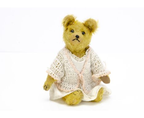 A Steevans jingling teddy bear circa 1915,  with golden mohair, black boot button eyes, pronounced muzzle, black stitched nos
