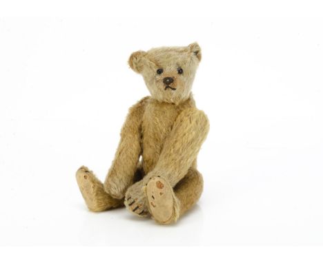 An early small Steiff teddy bear circa 1910,  with golden mohair, black boot button eyes, pronounced clipped muzzle, black st