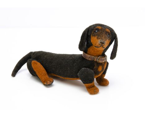An early Steiff black and brown burlap dachshund 1905-1910,  with black boot button eyes, black stitched nose, mouth and claw