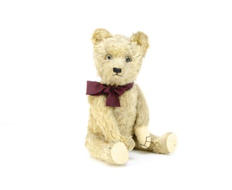 A 1930s teddy bear,  probably German with light golden mohair, clear and black glass eyes with remains of brown painted backs