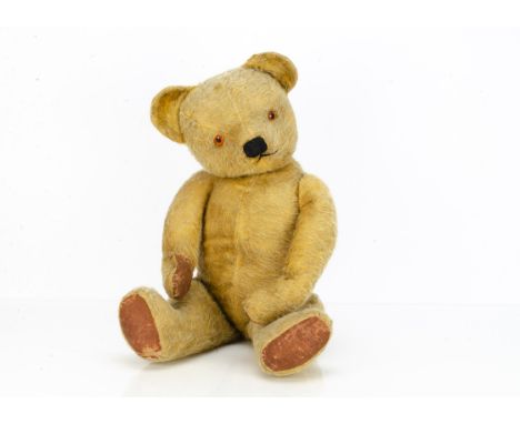 A post-war Chad Valley teddy bear, with golden mohair/mixed plush, orange and black plastic eyes, muzzle with black stitched 