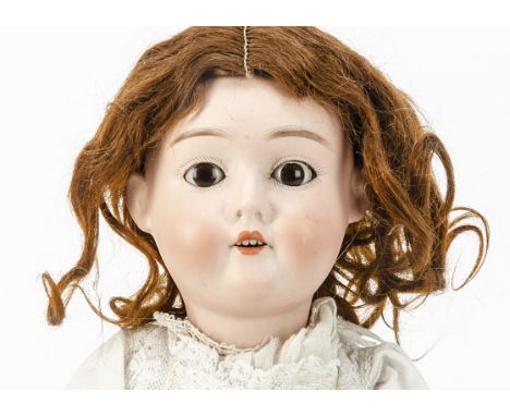 A Max Handwerck child doll,  with brown sleeping eyes, reddish brown mohair wig, jointed composition body and long cotton bab