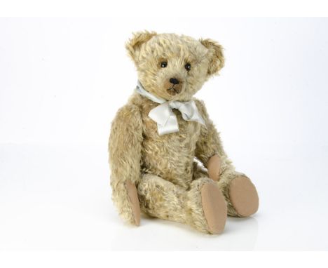 An early Strunz teddy bear 1908-1910,  with blonde mohair, black boot button eyes, pronounced muzzle, black stitched nose, mo
