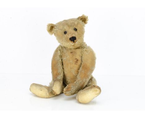 An early Steiff centre-seam teddy bear,  with blonde mohair, black boot button eyes, pronounced clipped muzzle, seam down cen