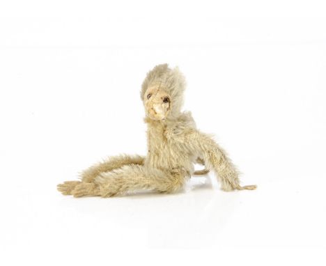 A Farnell World War One 'soldier' monkey, with blonde mohair, clear and black glass eyes with brown painted backs, felt face,