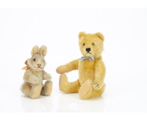 A post-war Steiff teddy bear,  with golden mohair, clear and black glass eyes with brown backs, pronounced muzzle, black stit