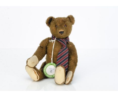 Brown Boy a 1920s Steiff teddy bear,  with brown mohair, brown backed glass eyes, pronounced muzzle, black stitched nose, mou