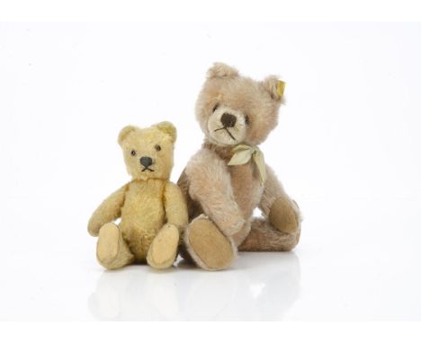 Two post-war Steiff teddy bears,   the smaller with golden mohair, clear and black glass eyes with brown backs, pronounced mu