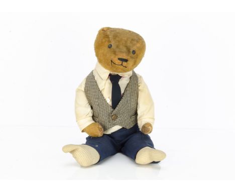 A German dressed teddy bear 1920s,  with short golden mohair, replaced button eyes, pronounced muzzle, black stitched nose an