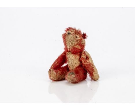 A rare World War One Farnell red mohair 'soldier' teddy bear, with one clear and black glass eyes, pipe-cleaner ears, swivel 