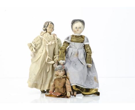 A German carved wooden shoulder-head doll,  with blue painted eyes and heavily carved black hair, stuffed body with compositi