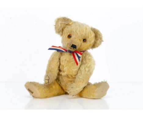 An early Merrythought teddy bear,  circa 1931, with golden mohair, orange and black glass eyes, pronounced clipped muzzle, bl