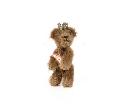 A Schuco miniature Berlin teddy bear 1950s,  with brown mohair, black metal pin eyes, black stitched nose and mouth, swivel h