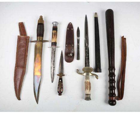 A small group of knives and edged weapons, including a mid-20th century hunting knife with etched double-edged blade, blade l