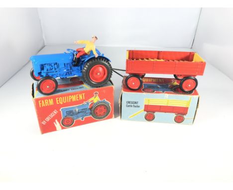 A Crescent toys farm tractor #1809 and a Crescent toys cattle trailer. Both boxed.