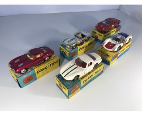 A selection of Corgi Toys model cars. A Chevrolet Corvette String Ray #310, an E Type Jaguar competition model #312, a Ferrar