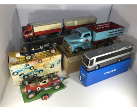 A collection of model vehicles. An NZG Model 1729 Pritcshen-Wagen #314 (trailer hitch join broken), a Gama Mechanik tin truck