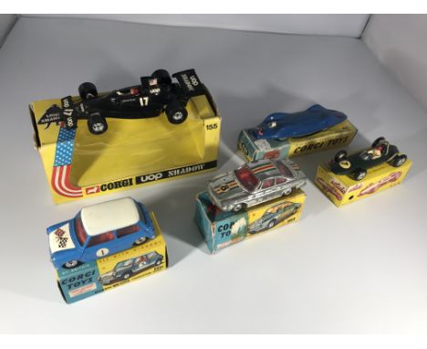A collection of racing vehicles. A Corgi UOP Shadow #155, a Corgi Toys Proteus Campbell Bluebird #153, a Morris Mini Cooper c