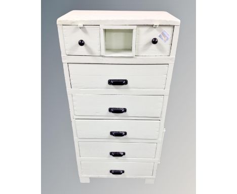 A vintage painted pine seven drawer chest 