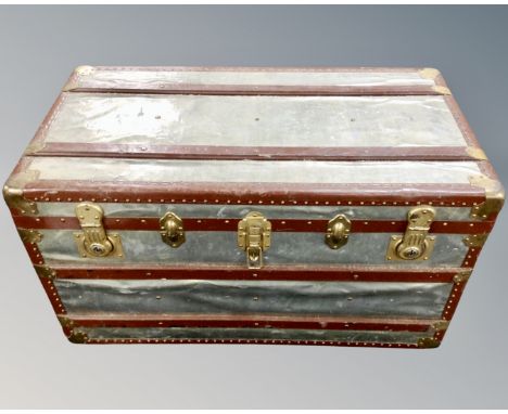 An early 20th century metal bound shipping trunk 