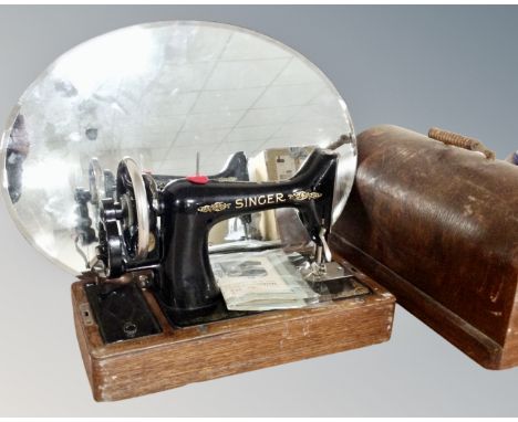 A vintage Singer sewing machine in case together with a frameless bevelled mirror 