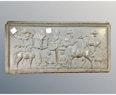 An antique cast iron fireplace plaque depicting wildlife and figures 