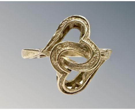 A 9ct yellow gold interlocking heart ring, 2.4g, size J/K.