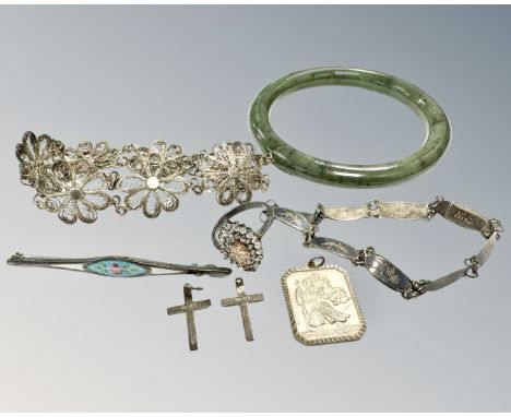 A jade bangle, together with Siam silver bracelet, silver religious fob, two silver crucifixes, an enamel white metal bar bro