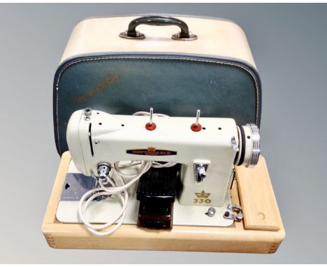 A vintage Dependable electric sewing machine in case 