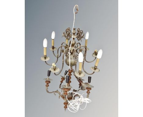 An antique continental brass eight branch chandelier together with a further metal and pottery five way chandelier.