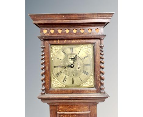 A 19th century oak longcase clock with brass dial, pendulum and key 