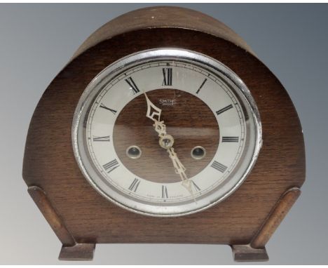 A 1930s oak cased Smiths Enfield eight-day mantel clock.