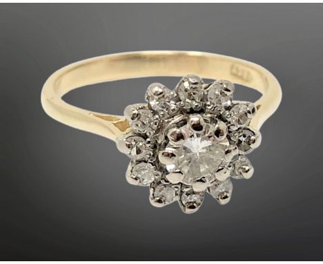 An 18ct gold diamond cluster ring, the central stone approx. 0.30 carat, size M CONDITION REPORT: 3g