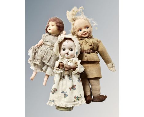 A vintage Japanese doll with key with two further vintage dolls 