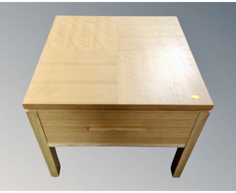 A contemporary oak lamp table fitted a drawer 