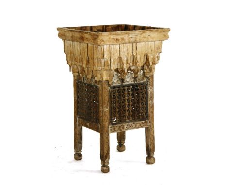 An unusual Moorish hardwood planter, the square section planter on carved supports with interlocking beadwork panels