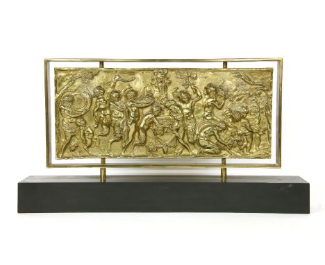 A gilt metal relief panel, depicting a mythological scene mounted on a black rectangular plinth, 51cm x 24cm