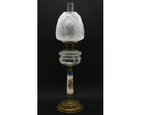 A 19th century oil lamp with porcelain column, and original shade and funnel