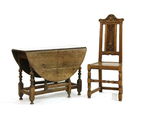 An oak gate leg table, 17th century, the oval drop leaf top on baluster and ring turned legs, top 122cm x 104cm, together wit