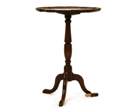 A George III mahogany elm tripod table, with a shaped circular top, 50cm diameter